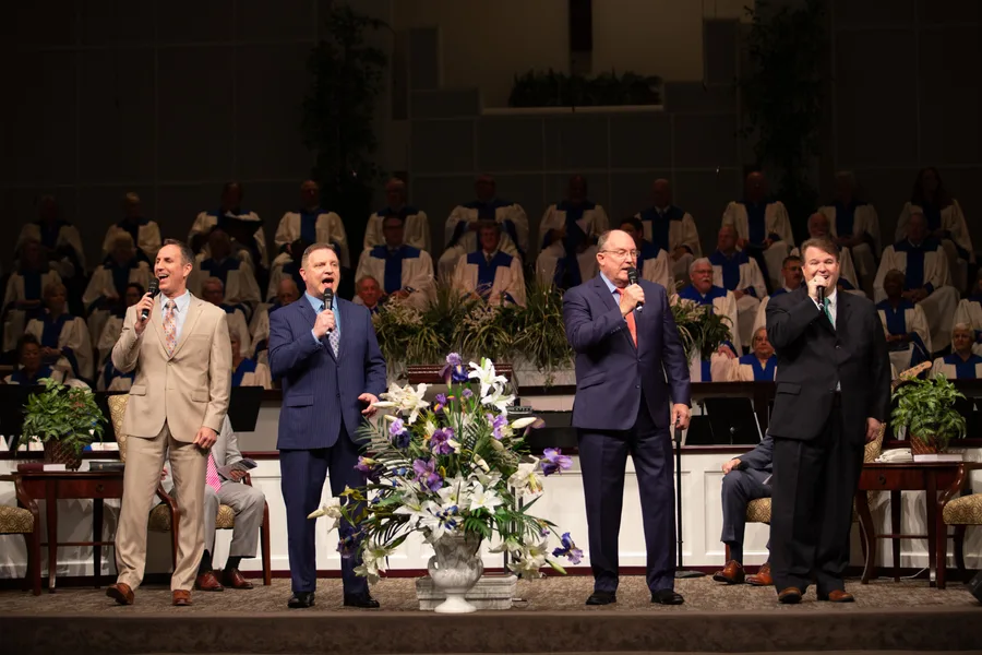 Four men singing from the platform with the Florence Baptist Temple choir behind them