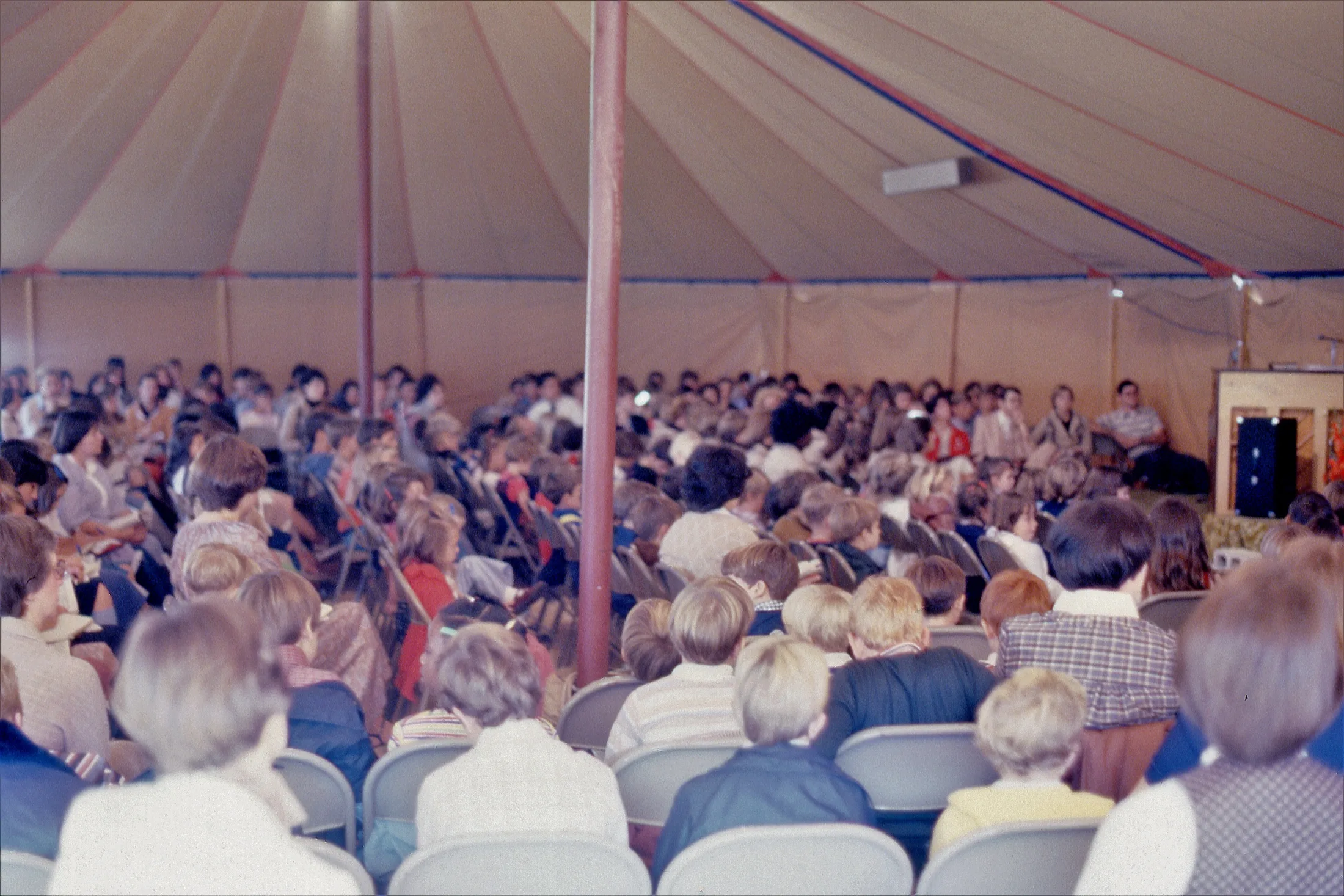 A large crowd gathered under a tent for a Florence Baptist Temple event